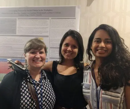 Three fellows sharing their research at the annual IACM conference