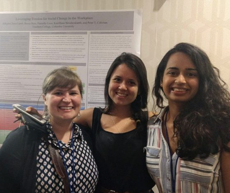 Three fellows sharing their research at the annual IACM conference
