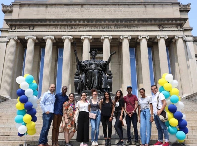 Participants of the first cohort of the Youth Leadership Program in front of the Columba University Low Library and the alma mater statue. 