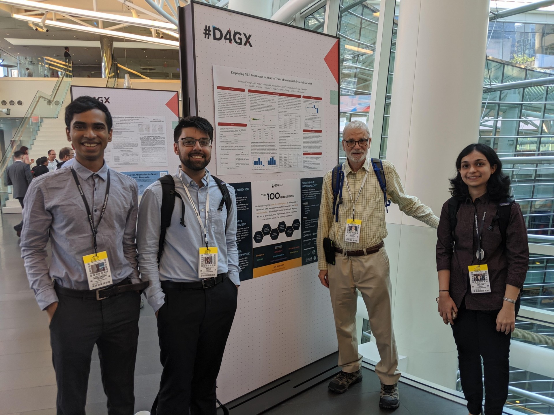 Three graduate students and Professor Larry Liebovitch at Bloomberg's Data for Good Conference in September 2019